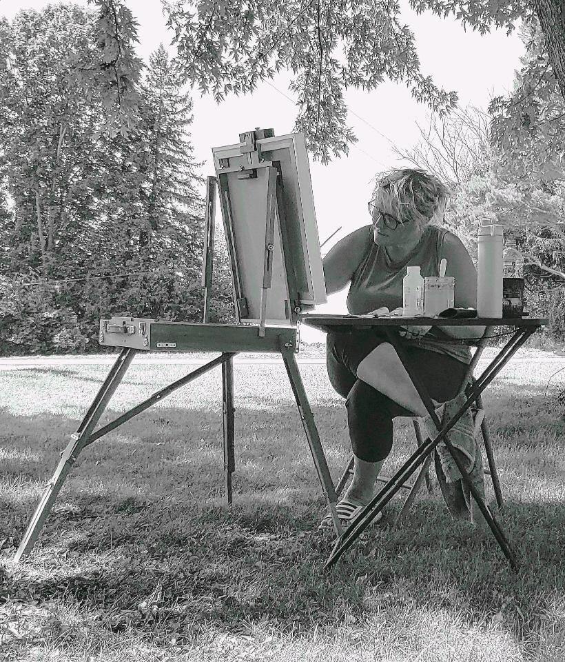 Shanda Brekke paints outside